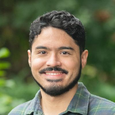 portrait of Eduardo Munguia Gonzalez smiling in front of blurred background