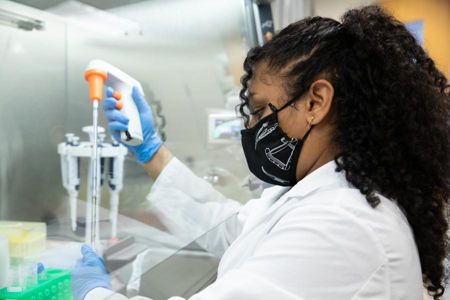Image of Supriya Kumar under the hood in the lab