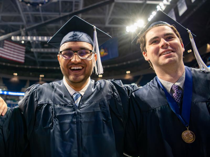 Three new Eberly College of Science alumni listening to the