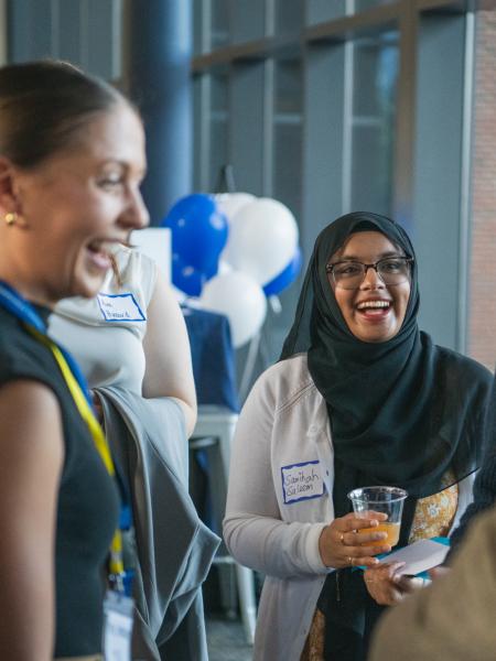 Students mingle at a networking event.