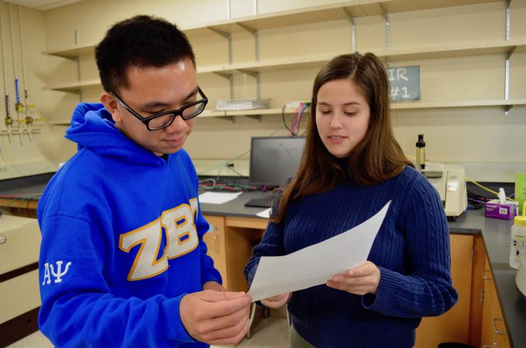 Students look at paper together