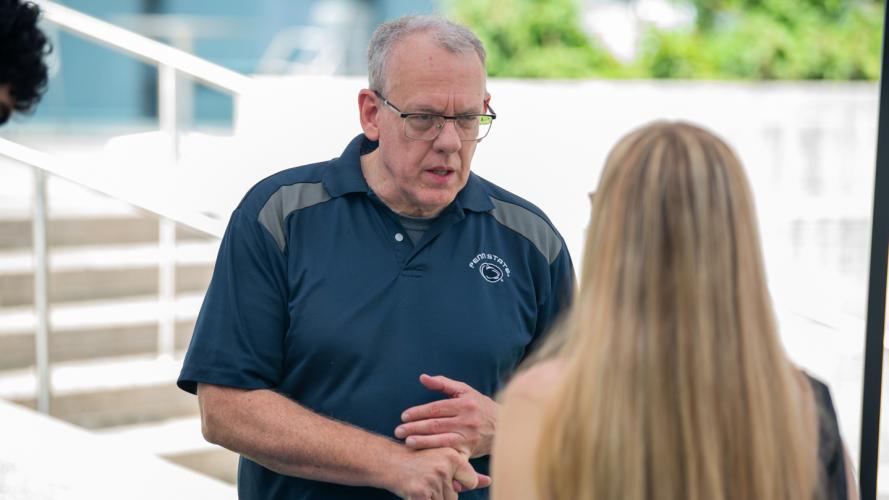 A Prehealth adviser talking with a new undergraduate student during a fall semester welcome day event.