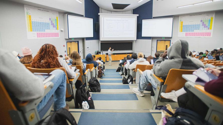 Matt Beckman speaks in a large lecture hall