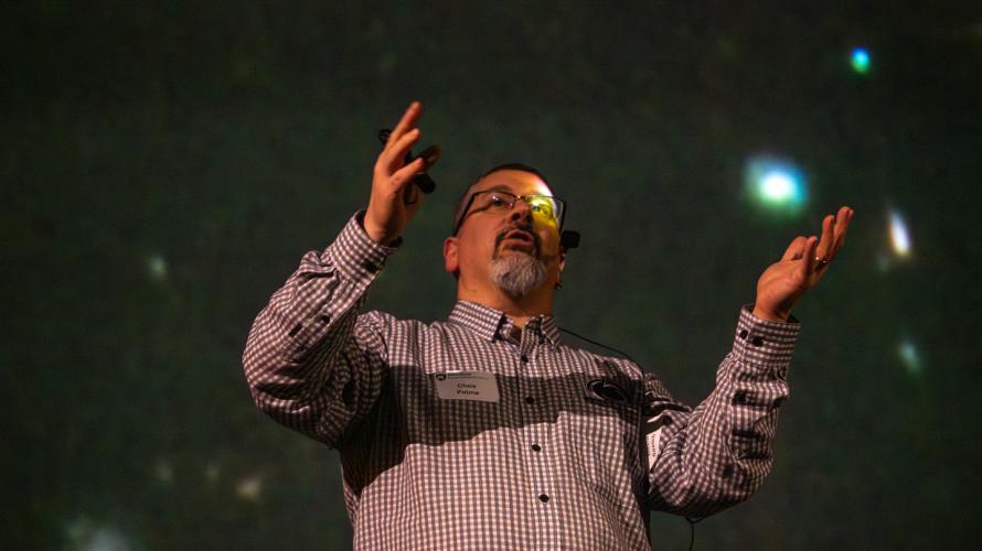 Chris Palma talking to the audience during a planetarium show.