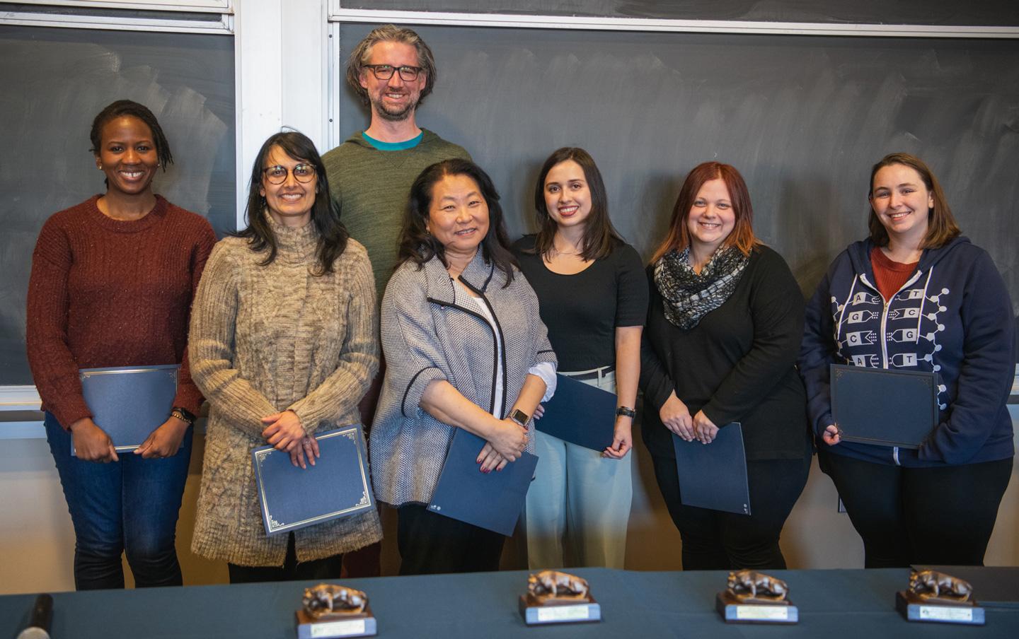 Award winners from the Dean's Climate and Diversity Award reception pose in front of a chalkboard for a group picture.