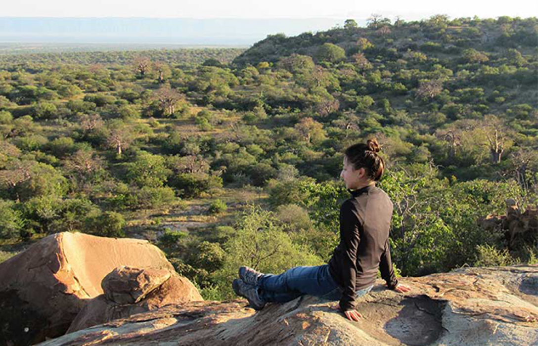 Student overlooking plains in Africa.