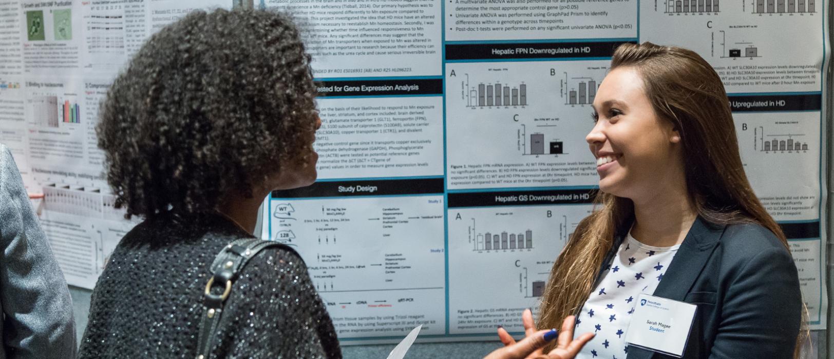 An enthusiastic student talking with a corporate representative.