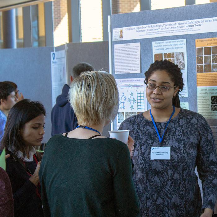 Student showing a poster