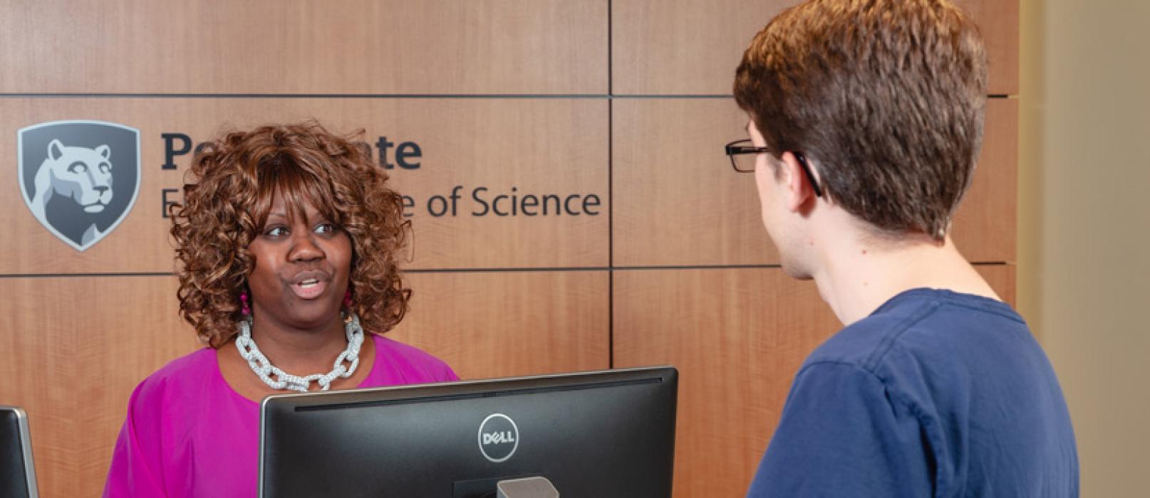 An undergraduate student talking to a member of the Office for Undergraduate Students.