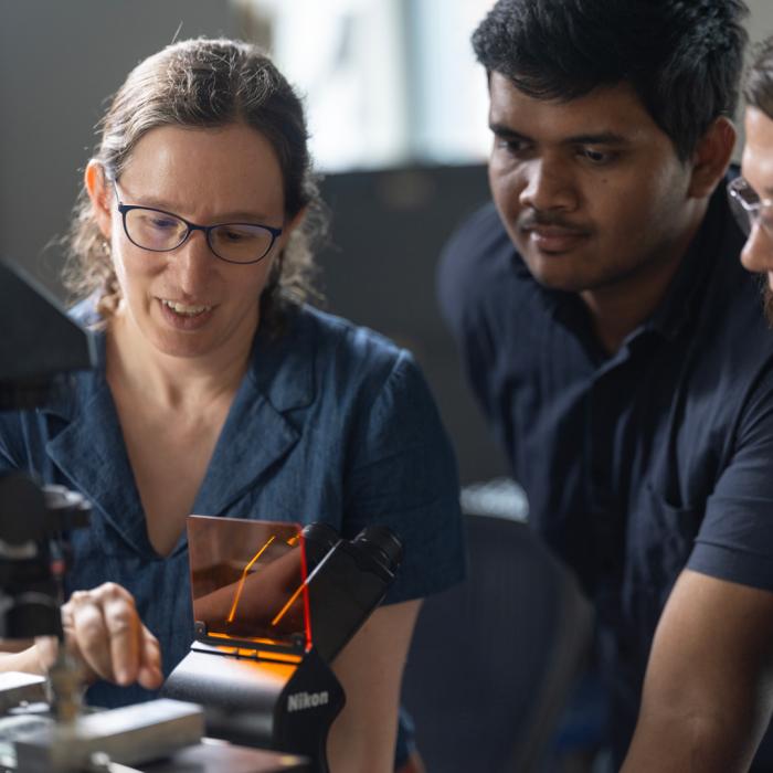 Miriam Freedman working in the lab with two graduate student researchers from her research group.