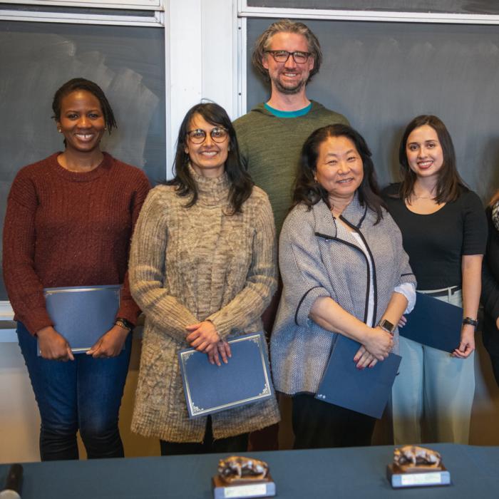 Award winners from the Dean's Climate and Diversity Award reception pose in front of a chalkboard for a group picture.