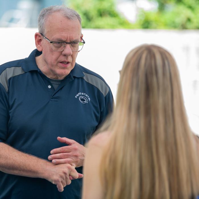 A Prehealth adviser talking with a new undergraduate student during a fall semester welcome day event.