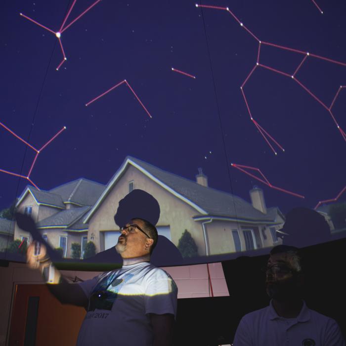 Chris Palma presenting to an audience at the planetarium during the 2025 AstroFest.