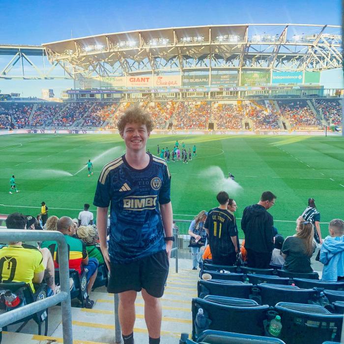 Max Gerhart stands a few steps above a soccer field 
