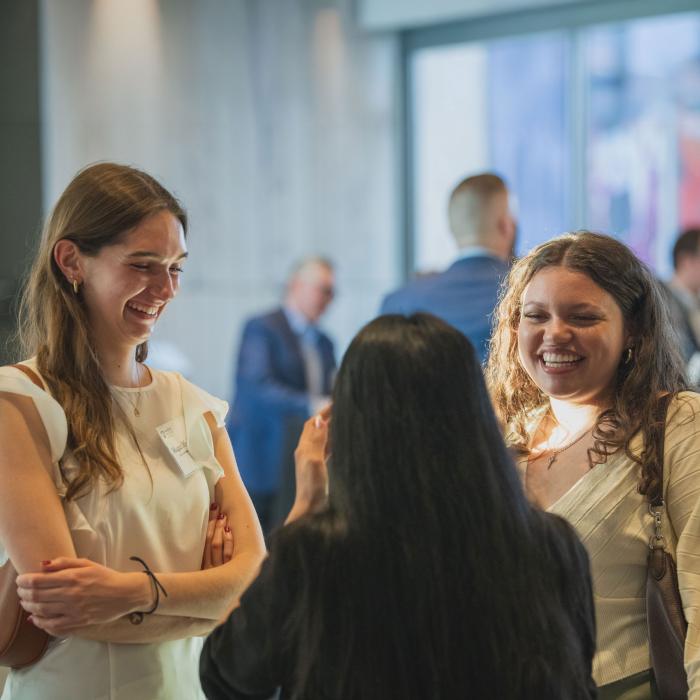 Students at talking and smiling during a mentoring event.
