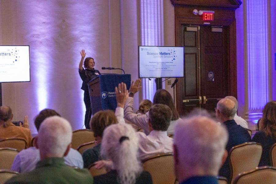 Tracy Langkilde, dean of the Eberly College of Science, raising her hand with audience members also raising their hands.