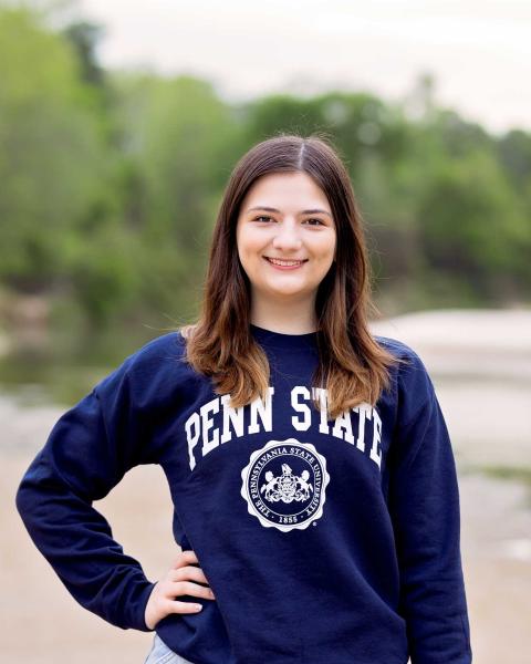 Kaitlyn Hammer wearing Penn State sweatshirt poses outside