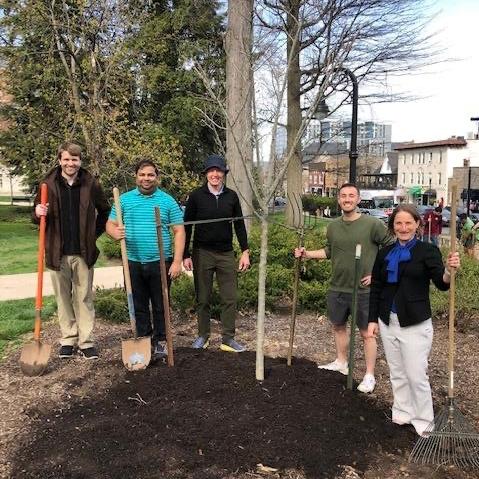 Tracy Langkilde and students planting a tree during the 2022 Earth Day.