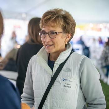 Alexa Dembek speaking with someone else at the Penn State Homecoming tailgate.