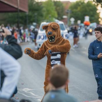 The Penn State Nittany Lion mascot walking through the Homecoming parade.