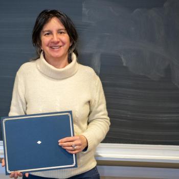 Nicole Lazar holding an award. 