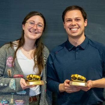 Emma Steinebronn and Stephen Paolini holding mini Nittany Lion statue awards.