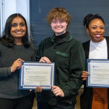 Group of people holding awards.