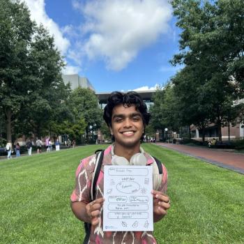 Student holding a first day of school paper sign.