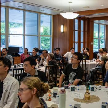 A photo of entire room with a packed audience at the event.