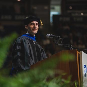 Commencement speaker Mario Ciabarra at the podium addressing graduates and their families.
