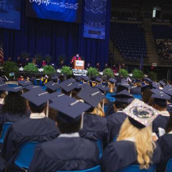 A view from behind the student section facing the stage.