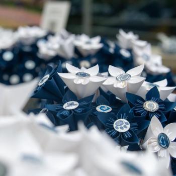 A bouquet of blue and white paper flowers featuring the Penn State mark.