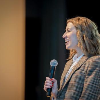 Attendee asking a question with a microphone during a session.