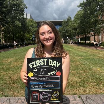Kaelonnah Darlich holding a first day of school board.