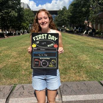Female science student holding a first day of school board.