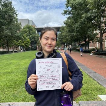 Student holding a first day of school paper sign.