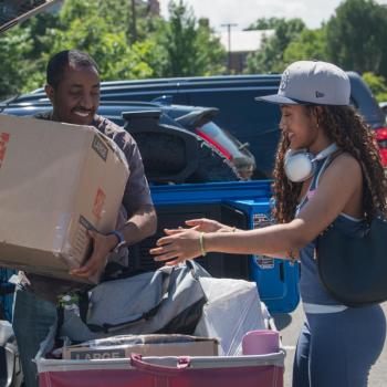 Two people unpacking during Move In Weekend at Penn State.