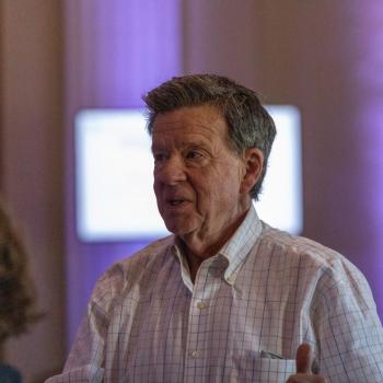 One of the attendees at the Franklin Institute speaking to someone else