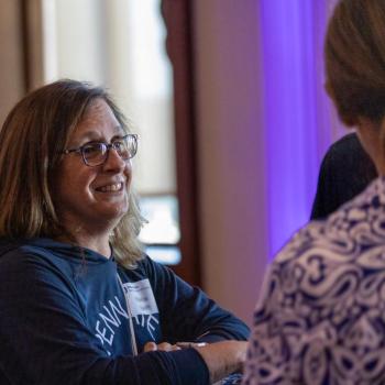 Maria Swift speaking to others at the Franklin Institute
