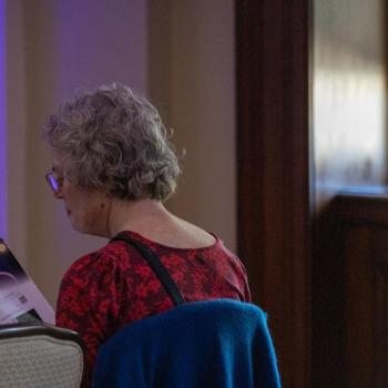Science Matters: Spotlight Sessions event attendee sitting and reading the Science Journal
