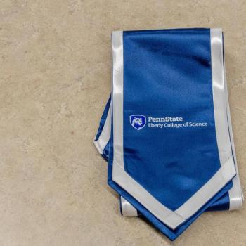 Photo of a commence stole with the college mark reading "The Eberly College of Science."