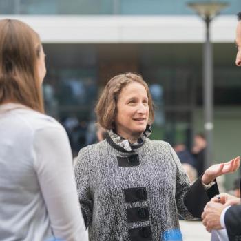 Our Dean, Tracy Langkilde talking to the commencement speaker and a student at the reception.