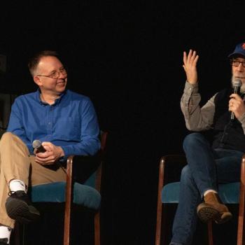 Wright and Frank sitting on stage